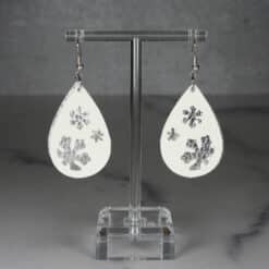 White Glitter and Silver Embossed Faux Leather Snowflakes Teardrop Earrings - Front