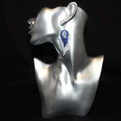 Silver Embossed, Blue Glitter and Leaf Charm Faux Leather Feather Earrings - Head